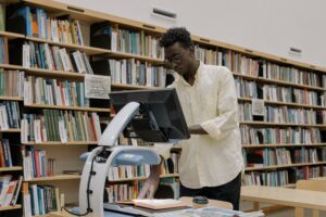 man in a library using a scanner, viewer to take an image of a page